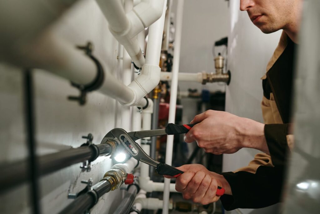 Plumbers maintaining commercial plumbing pipes in Edgewater
