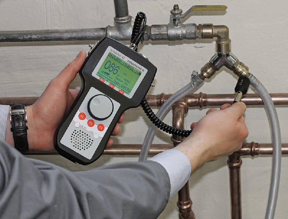 Plumber testing pipes with electronic leak detection equipment in Edgewater