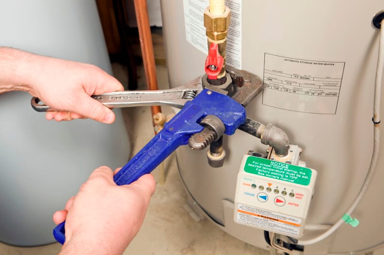Plumber repairing a water heater valve in Edgewater